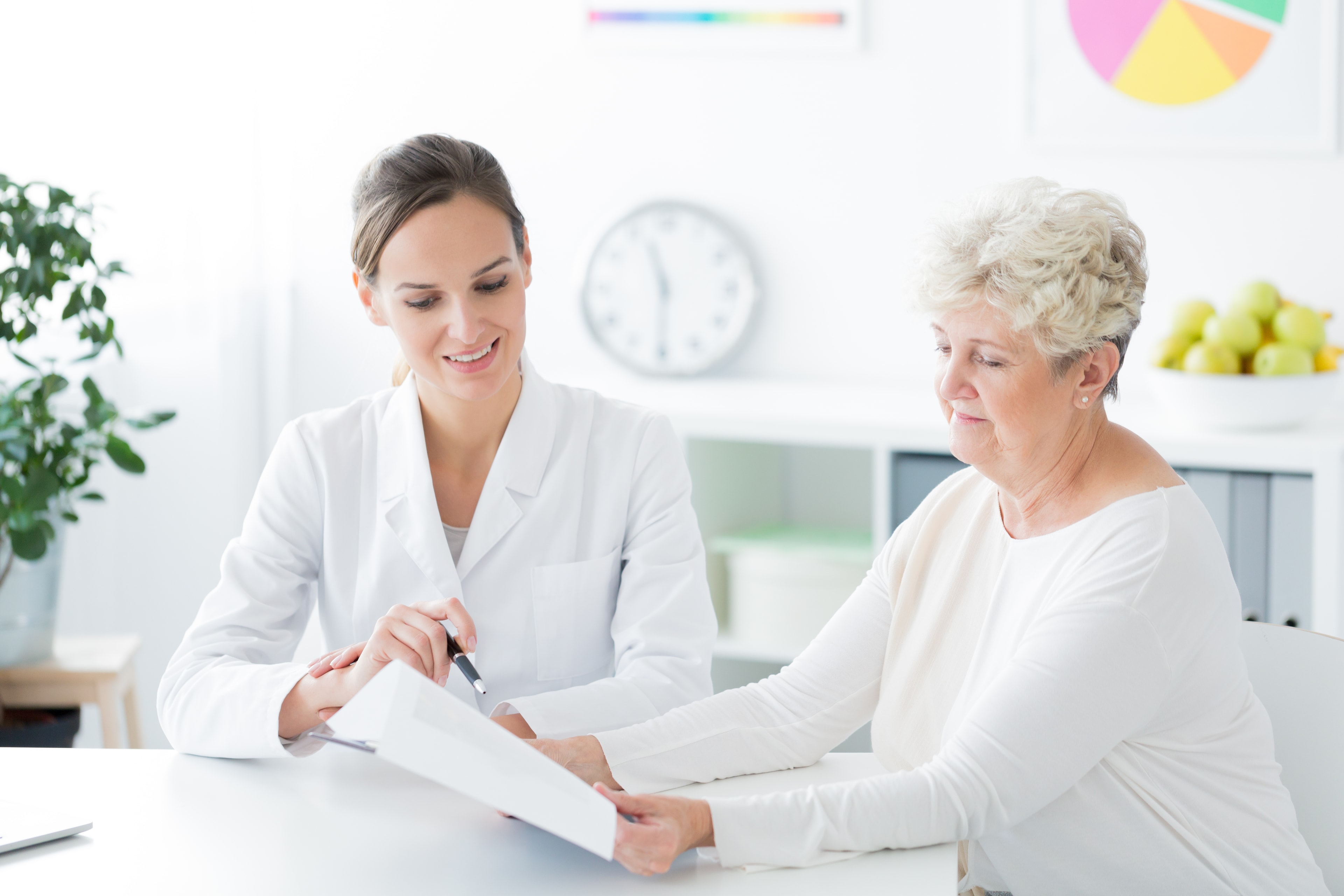 Hospice care coordinator reviewing coverage options with a senior patient